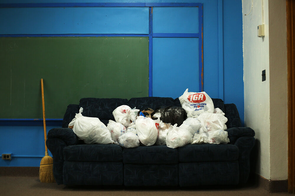 A collection of plastic bags was stored on a couch in the storage room